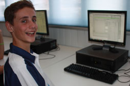 Student sitting at desktop computer.