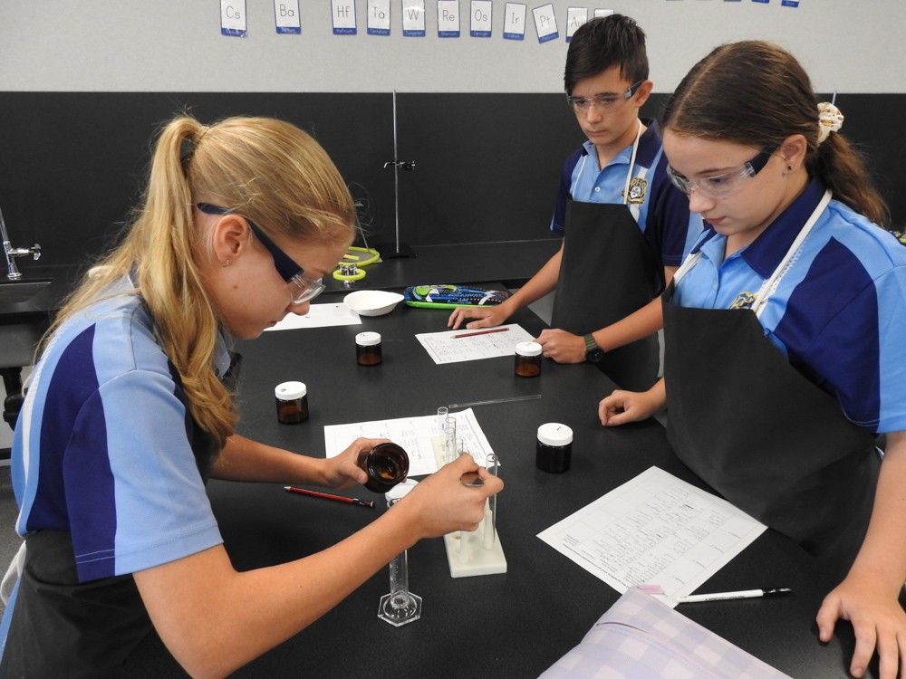 Two female students in science class doing experiment.